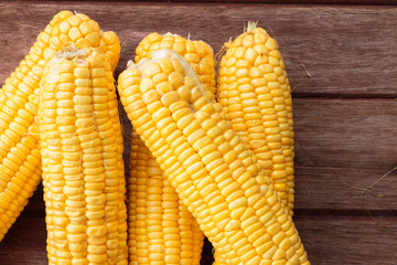 Fresh sweet corn on wooden table