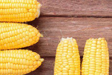 Fresh sweet corn on wooden table