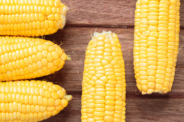 Fresh sweet corn on wooden table