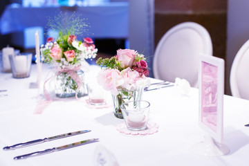 Table set in pink and white for wedding or event party.