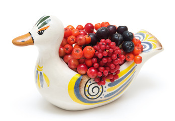 Berries in ceramic duck isolated on white