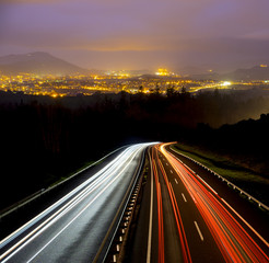 car lights at night on the road going to the city © poliki