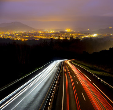 car lights at night on the road going to the city