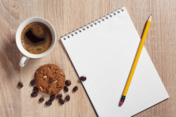 Coffee with cookie and notepad