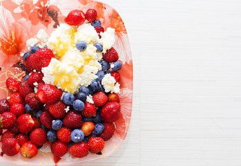 Healthy breakfast cottage cheese with blueberry and strawberry