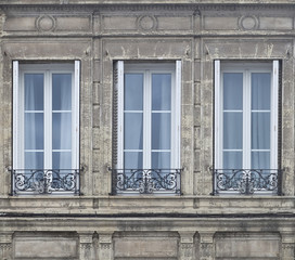 Fototapeta na wymiar Three French Doors. In large cities in the traditional buildings, french doors are found everywhere. Complimenting the doors are black wrought iron railings.