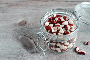 Red and white spotted beans in a glass jar
