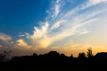 Bright sunset in sky over Vang Vieng landscape, LAOS.