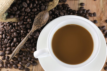 White coffee cup and roasted coffee beans.