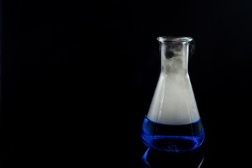glas with a blue liquid used for chemical analysis..
