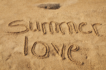Fototapeta premium The words Summer Love written in the sand on the beach