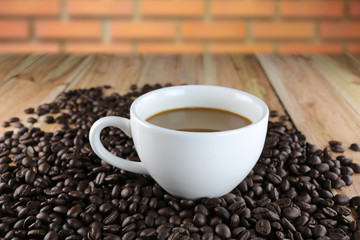 White coffee cup and roasted coffee beans.