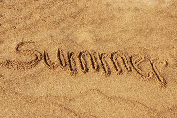 The word Summer written in the sand on the beach