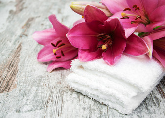 Pink lily and  towels