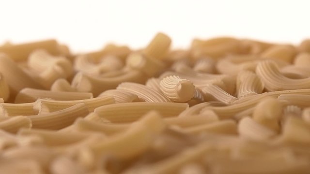 Falling down Italian pasta, on white, rotation, close up, slow