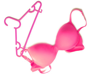 Pink bra hanging on a hanger isolated on a white background
