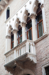 Obraz premium View of a balcony and columns of Cavalloni Thiene Palace in the historical Contrà Porti Street of Vicenza