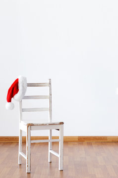 Santa Claus Hat Hanging On Empty Wooden Chair