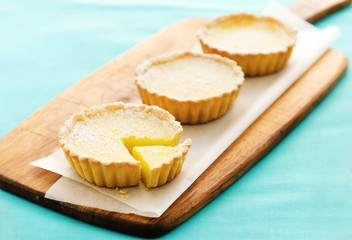 Lemon tarts on a wooden serving board