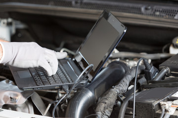 Car mechanic with a tablet