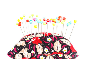 Pincushion with pins isolated on white background