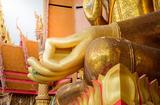 closeup at hand of Gold big buddha statue temple wat tham sua