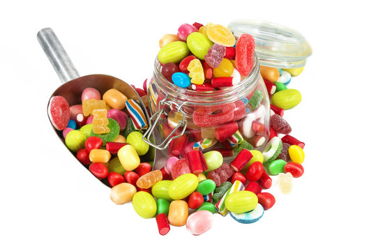 Glass jar full of candies isolated in white background