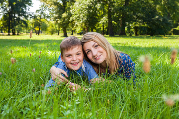 Fototapeta premium young mother and son lying on the meadow