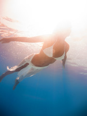 beautiful woman in white dress underwater