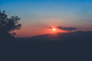 Sunset with mountains and trees