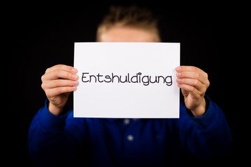 Child holding sign with German word Entschuldigung - Sorry