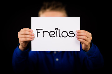 Child holding sign with German word Freilos - See You Later