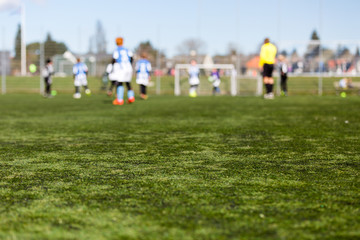 Obraz na płótnie Canvas Blurred Kids Playing Football