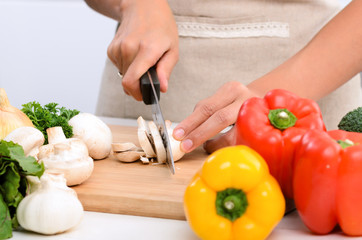 Obraz na płótnie Canvas Close up of hands slicing vegetables with knife