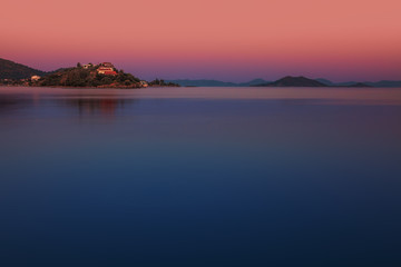 Beautiful Sunset on the sea, in the background mountains