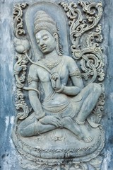 Fototapeta na wymiar woman statue on the wall in temple , Thailand