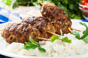 Barbecued kofta with rice on a plate - 89233442