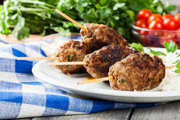 Barbecued kofta with rice on a plate