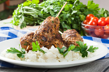 Barbecued kofta with rice on a plate