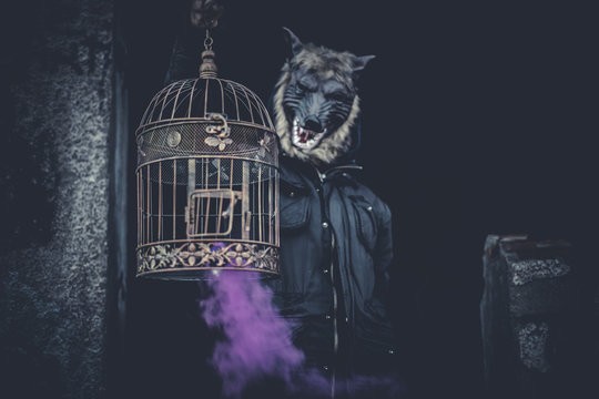 Scary, man with mask wolf and lamp with colored smoke