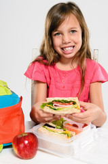 Elementary school girl about to eat her packed lunch