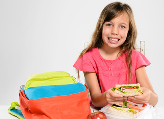 Elementary school girl about to eat her packed lunch