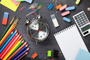 School supplies on blackboard background