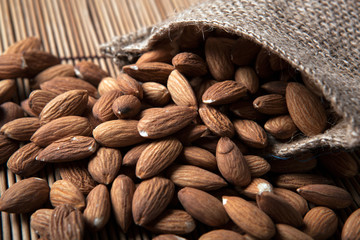 large grains of almonds in the shell and the bag