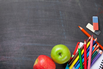 School supplies on blackboard background