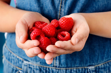 Holding raspberries in her hand