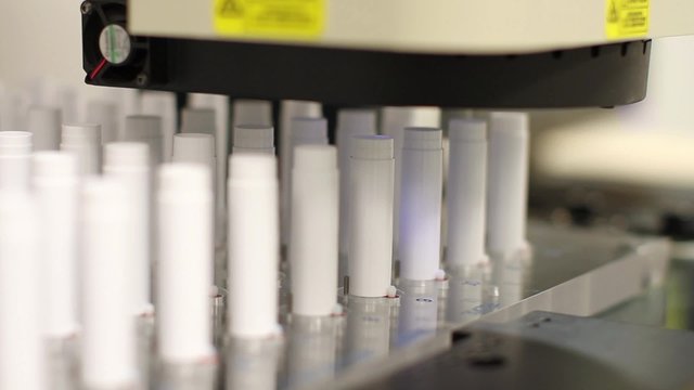 An automated robotic camera inspects a product at a microscopic level in a factory
