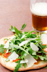 Individual pizza snack with beer
