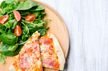 Pizza with salad dinner on rustic background