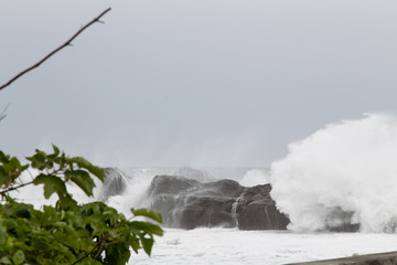 Stormy sea with waves crashing on rocks